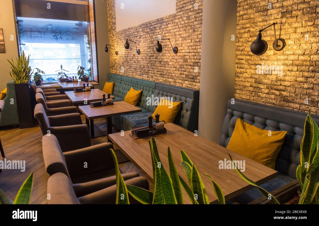 Cozy restaurant interior with sofas and tables for quick lunch Stock