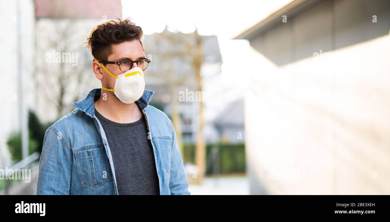 Portrait of a young man with breathing mask outdoors Stock Photo