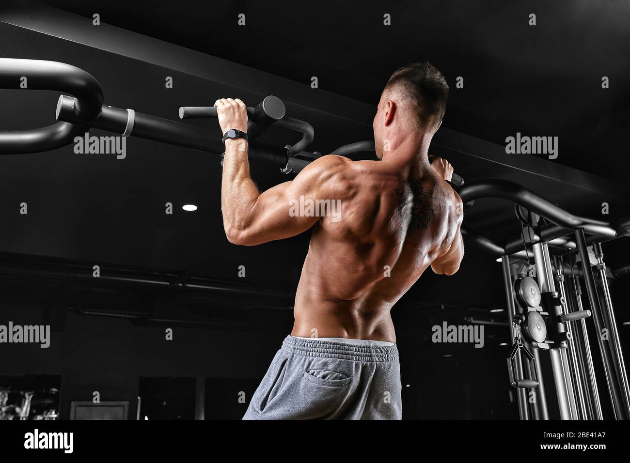 The athlete does a pull-up on the horizontal bar. A man in great