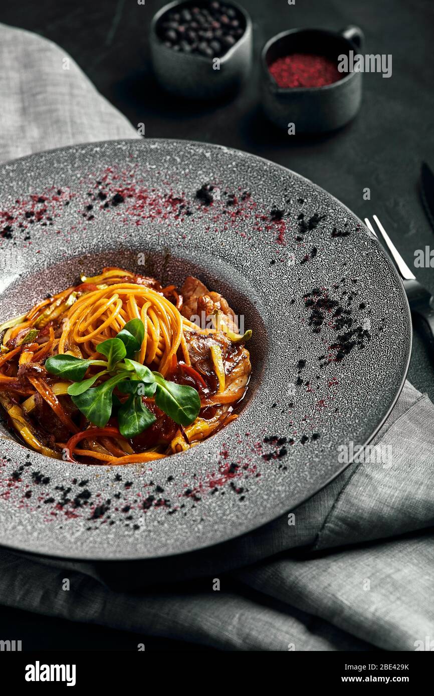 Spaghetti with vegetables tomato sauce and meat. Traditional italian