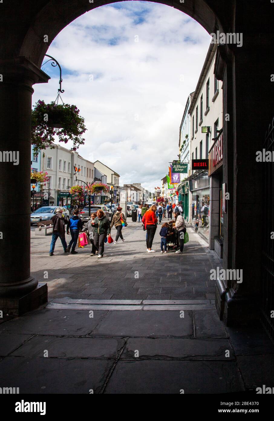 An arch of the old town hall (1761) frames Kilkenny's High Street today, a strip also called the Medieval Mile. Stock Photo