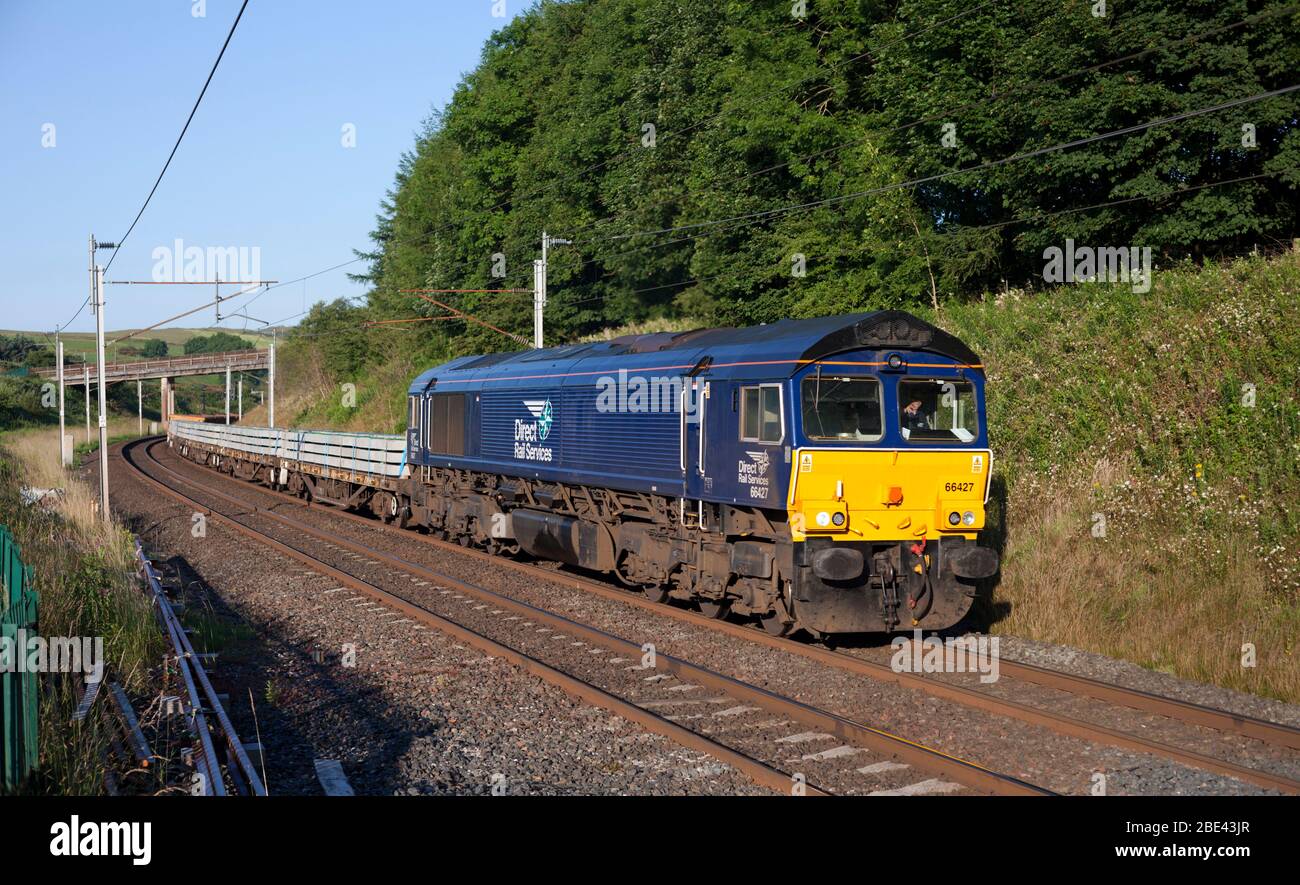 Direct rail Services class 66 locomotive on the west coast mainline with freight train carrying materials for Network Rail national delivery service Stock Photo