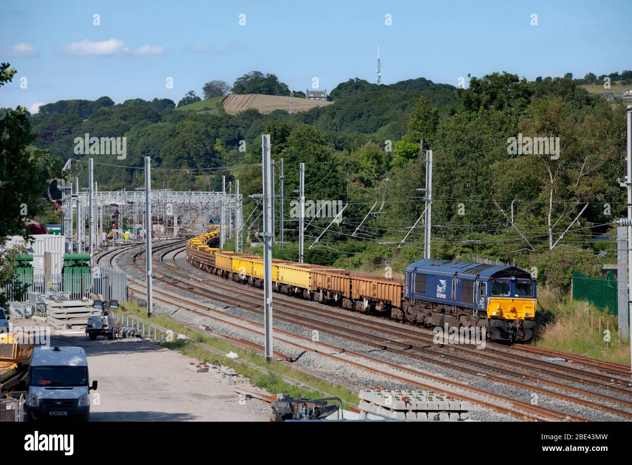 Direct rail Services class 66 locomotive on the west coast mainline with freight train carrying materials for Network Rail national delivery service Stock Photo