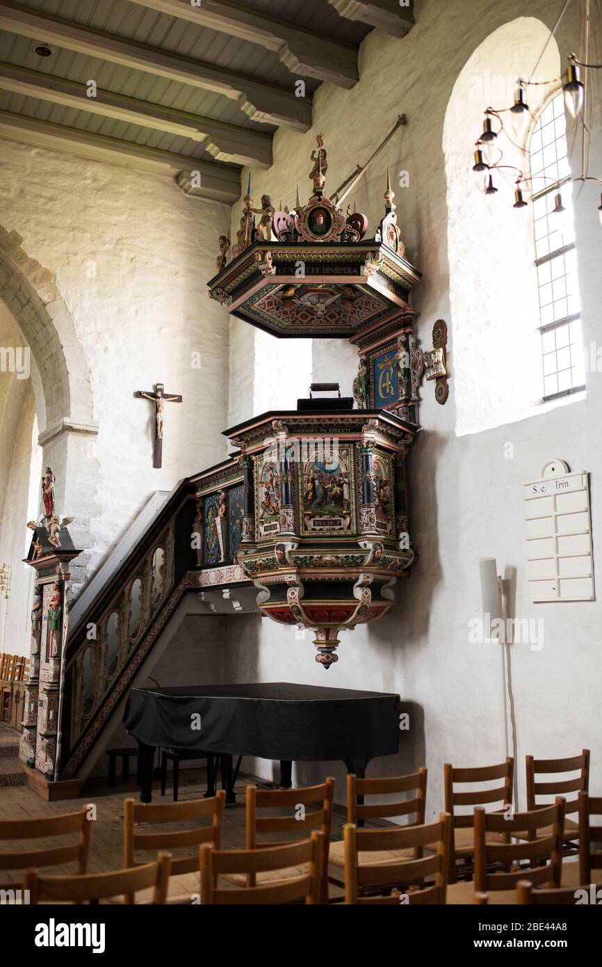The pulpit of the Aa-kirke (Aa Church), a romanesque church with medieval origins, in the town of Aakirkeby on the island of Bornholm in Denmark. Stock Photo