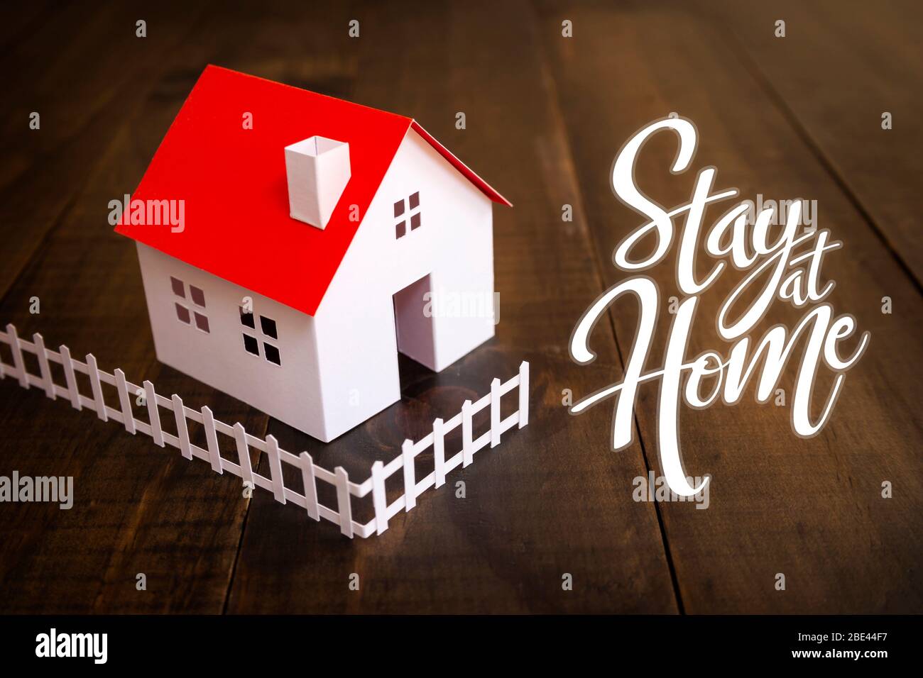white paper house with text 'stay at home' with copy space. Social distancing campaign during coronavirus pandemic Stock Photo