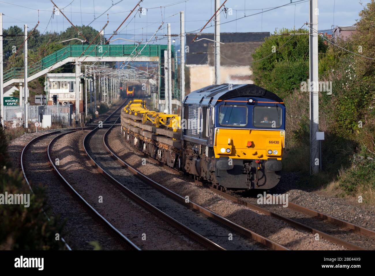 Direct rail Services class 66 locomotive on the west coast mainline with freight train carrying materials for Network Rail national delivery service Stock Photo