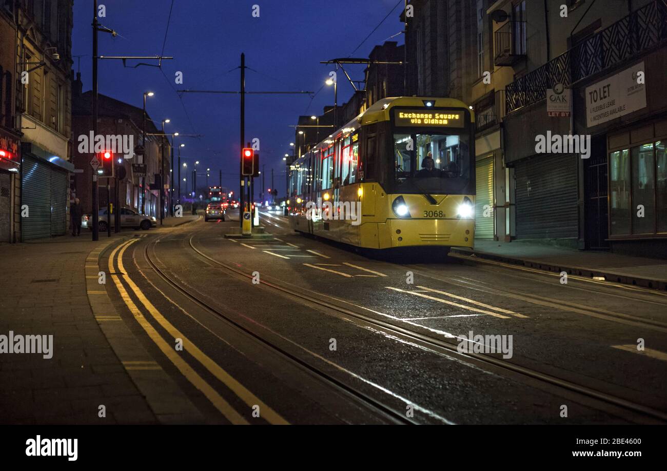 Manchester Metrolink Bombardier Flexity M5000 tram running along Drake street, Rochdale at dusk Stock Photo