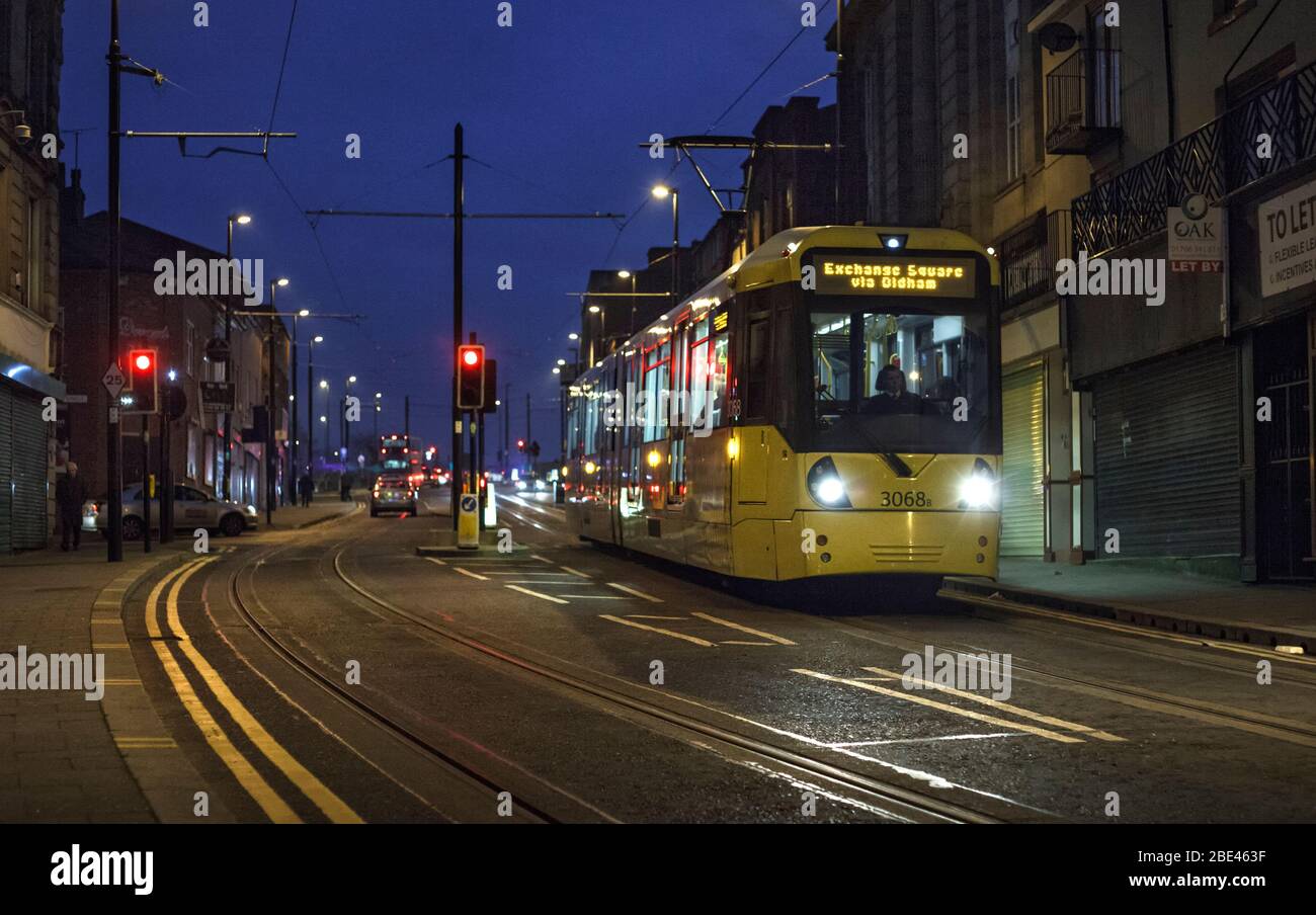 Manchester Metrolink Bombardier Flexity M5000 tram running along Drake street, Rochdale at dusk Stock Photo