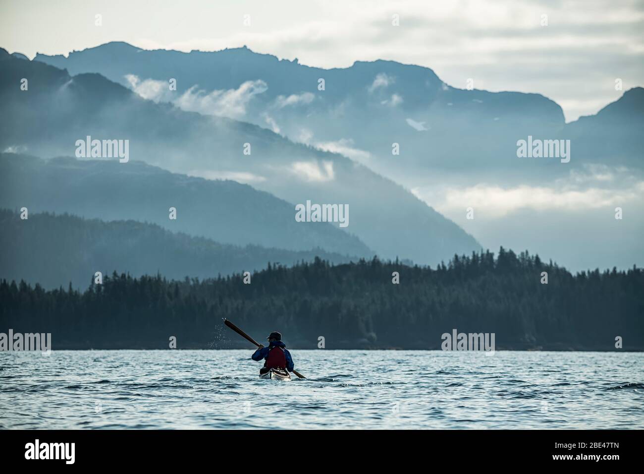 Kayaker paddling in Prince William Sound; Alaska, United States of America Stock Photo