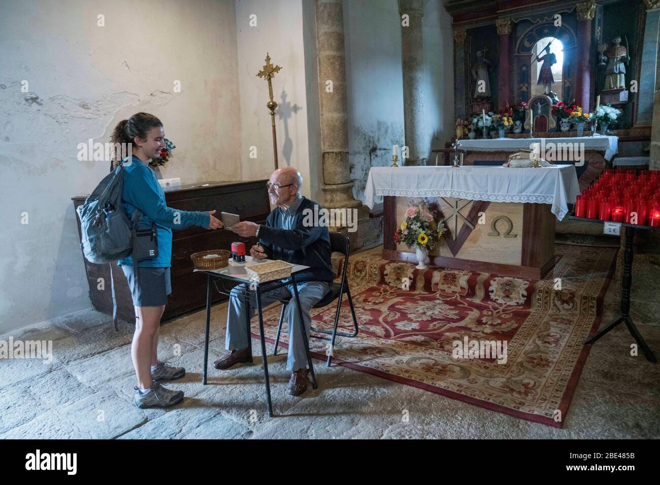 Spain, Galicia, Lugo, Palais de Rei, Camino de Santiago, the way of St. James. Pilgrims getting their passport stamped in a church. Stock Photo