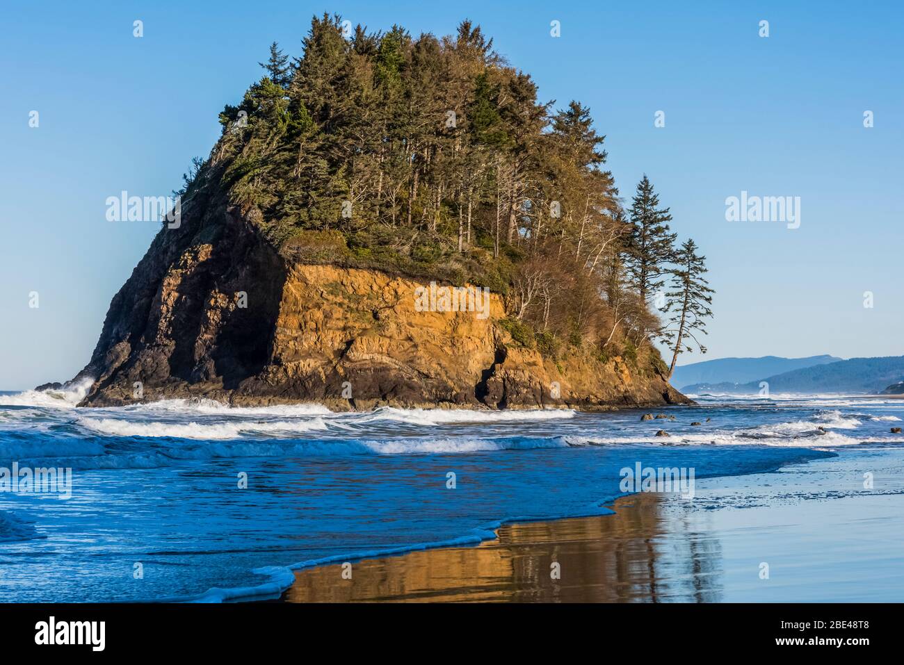 Surf washes around the foot of Proposal Rock at Neskowin Beach on the Oregon Coast; Neskowin, Oregon, United States of America Stock Photo