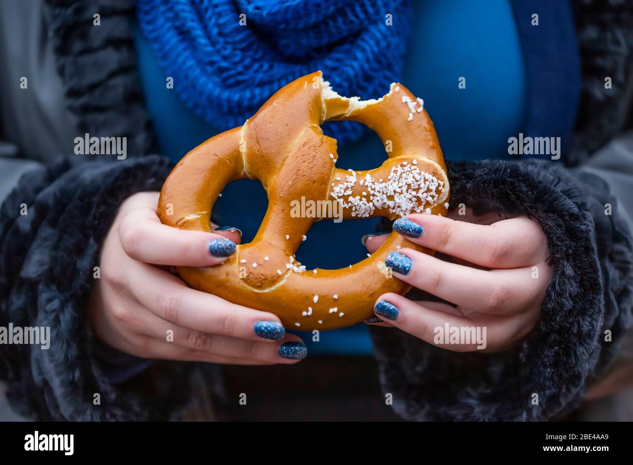 Woman eating a pretzel; New York City, New York, United States of America Stock Photo