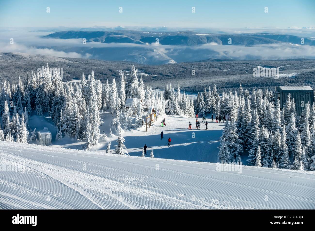 Skiiers outside a building at Sun Peaks Resort in the Rocky Mountains;  Sun Peaks, British Columbia, Canada Stock Photo