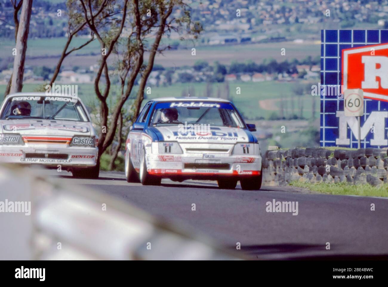 Bathurst, Australia, October 5th, 1986: Enzed Team Perkins, Holden VK Commodore SS Group A car, races with one of two Mobil Holden Dealer Team cars of the same model at the 1986 James Hardie (Bathurst) 1000 race. The cars are pictured on part of the steep uphill section of the 6.213km street circuit Stock Photo