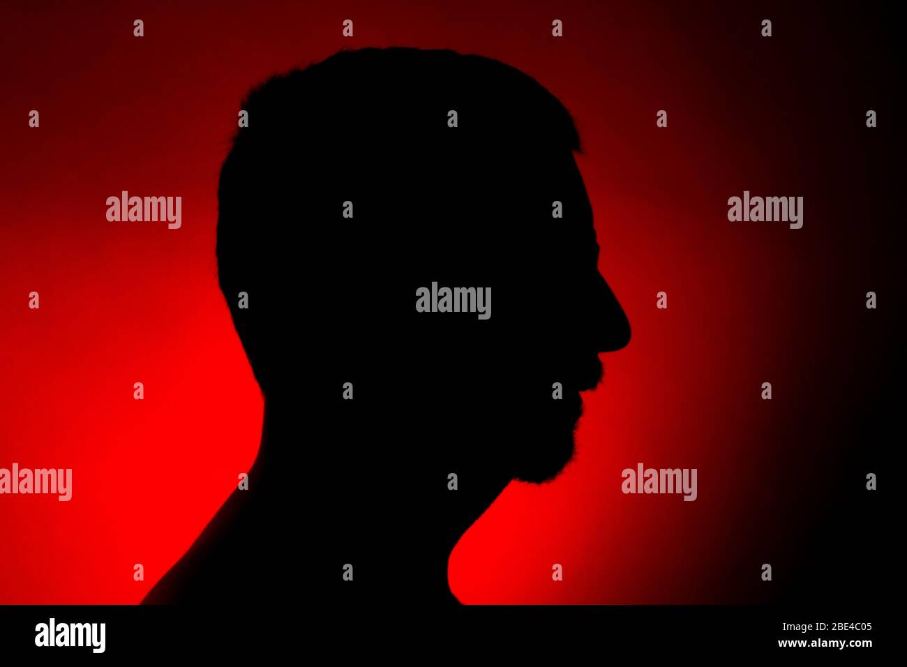 Cleanly defined silhouette of a male person against a red