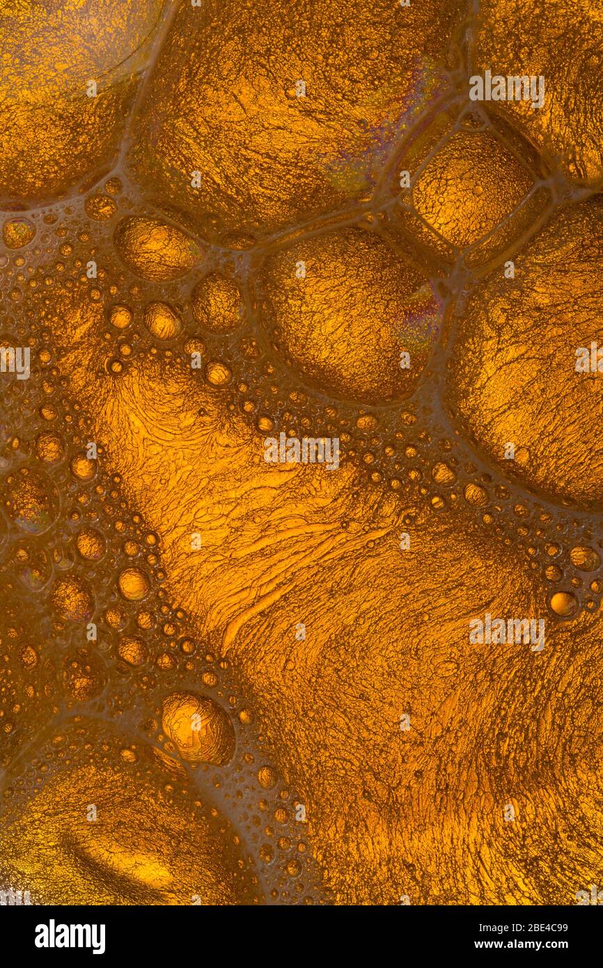 abstract background with bubbles oil. Yellow Soap Bubbles Stock Photo