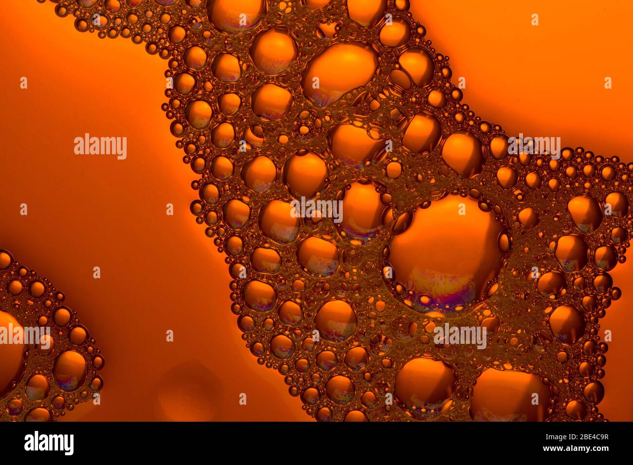 Bubbles and drops close up.  orange  liquid background Stock Photo