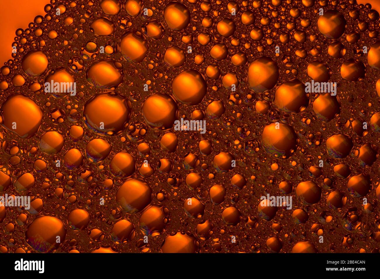 orange and yellow liquid background. foam texture. close up Stock Photo