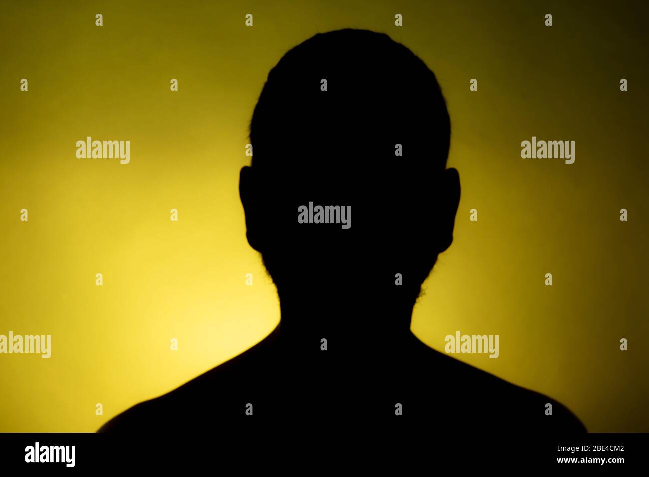 Cleanly defined frontal silhouette of a male person against a blue