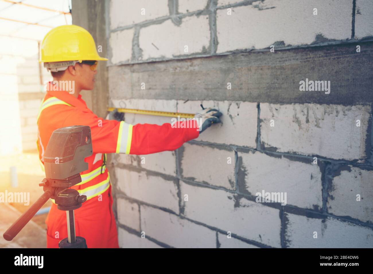 Technician with Laser measurement level during work Stock Photo