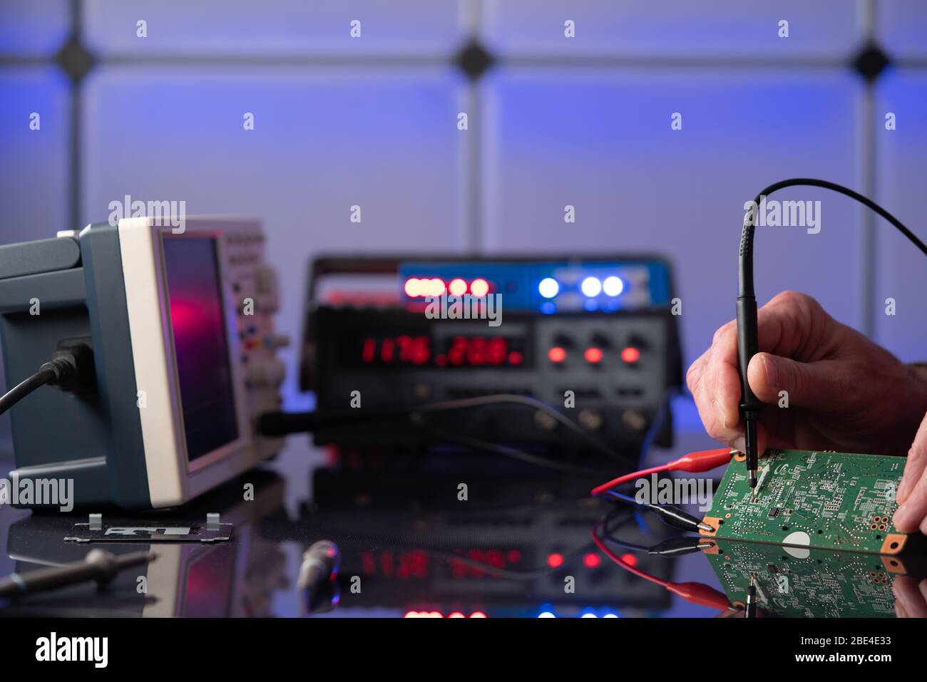 Debugging electronics device. PCB witch microcontroller in electronics laboratory Stock Photo