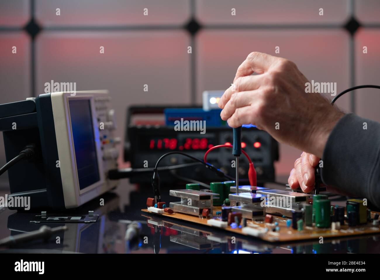 Debugging electronics device. PCB witch microcontroller in electronics laboratory Stock Photo