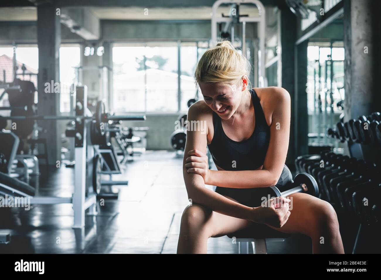 Woman have accident injury and hurt at arms while workout and weight