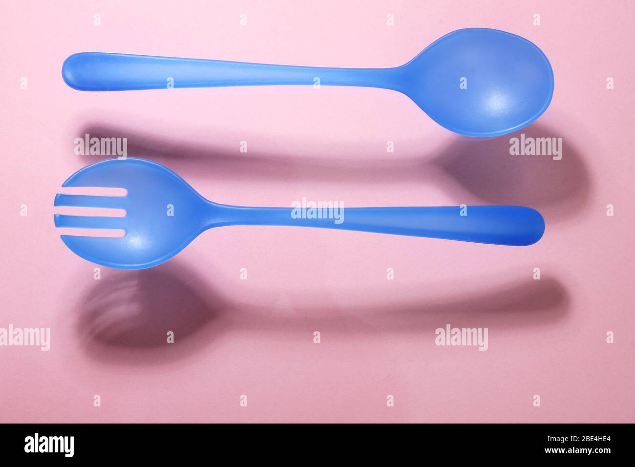Plastic Fork and Spoon on Pink Background Stock Photo Alamy