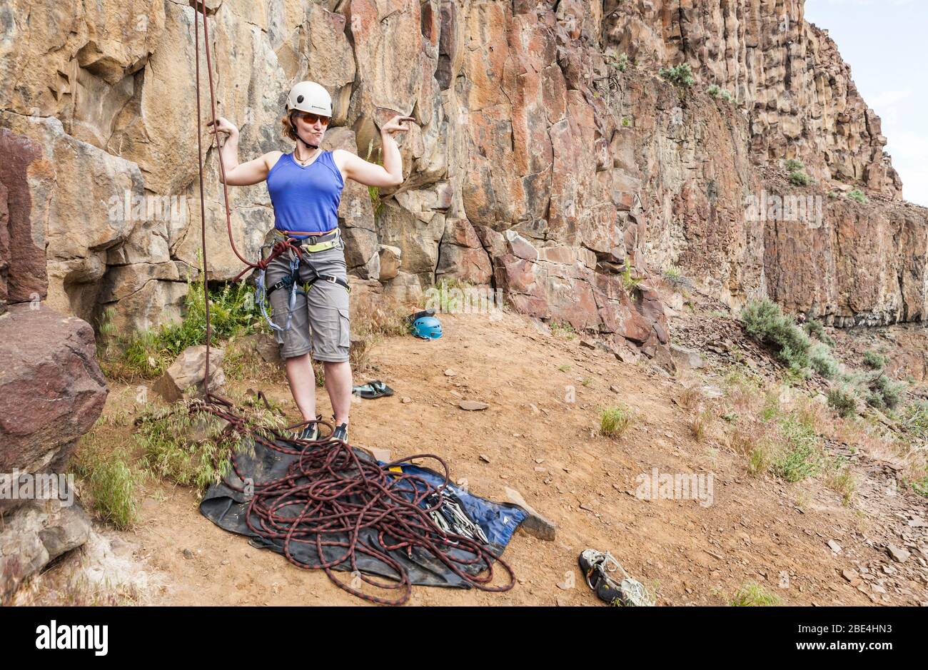 A mide 40's woman posing before starting a rock climb in Eastern Washington. 'The Gun Show'. Stock Photo