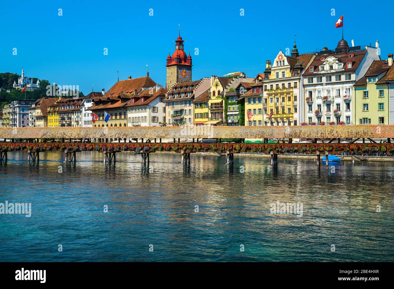 Swiss touristic and travel location in Lucerne. Admirable cityscape view with flowered wooden Chapel bridge on the Reuss river, Luzern, Switzerland, E Stock Photo