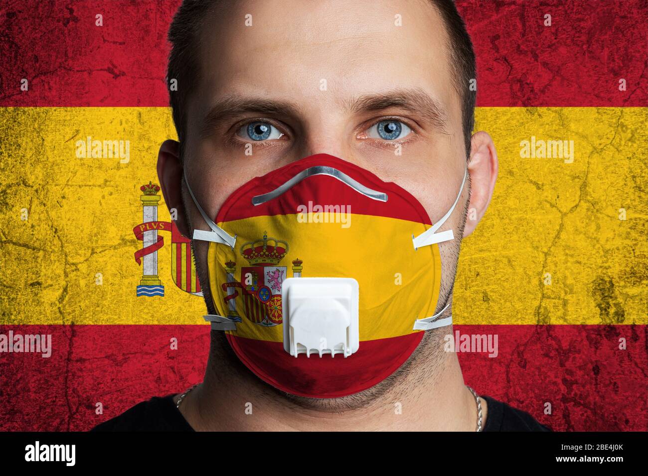 Red Mask Spain Young man with sore eyes in a medical mask painted in the colors of the ...