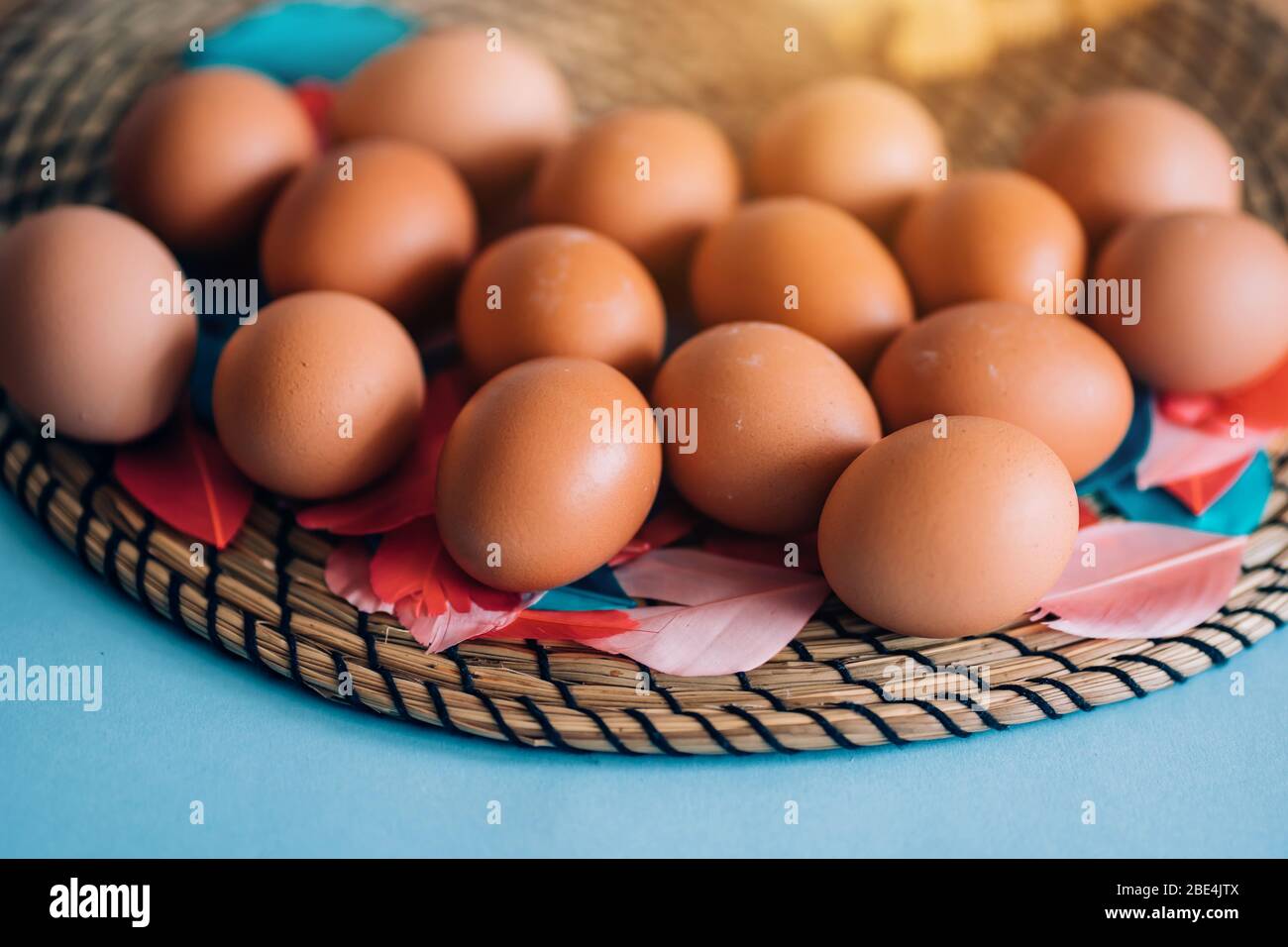 Closeup view from above lots of eggs on a blue pastel background with copy space. Happy Easter, food, spring, holiday concept Stock Photo