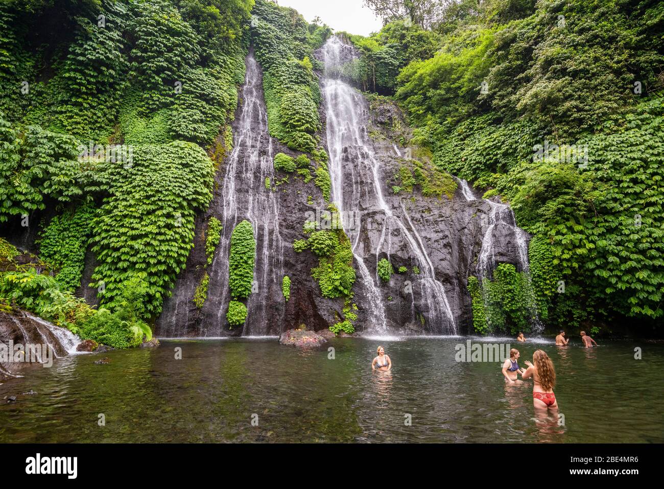 Horizontal view of tourists enjoying the Banyumala Waterfalls in Bali, Indonesia. Stock Photo