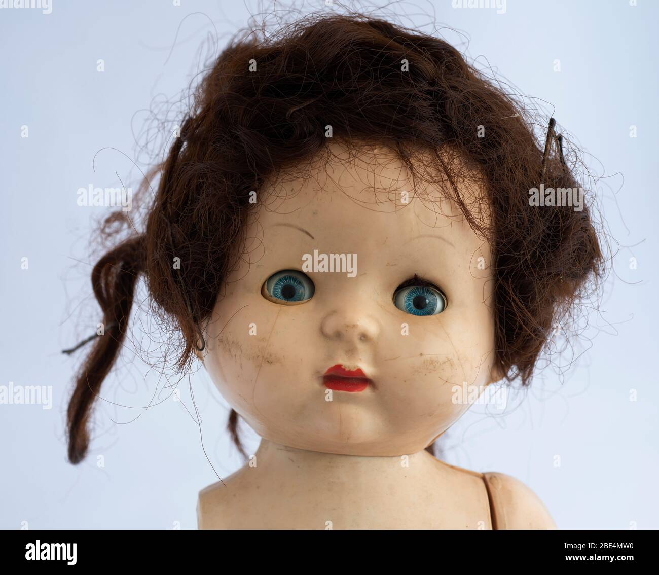 Vintage blue eye doll portrait .Red lipstick  and bad hair Stock Photo
