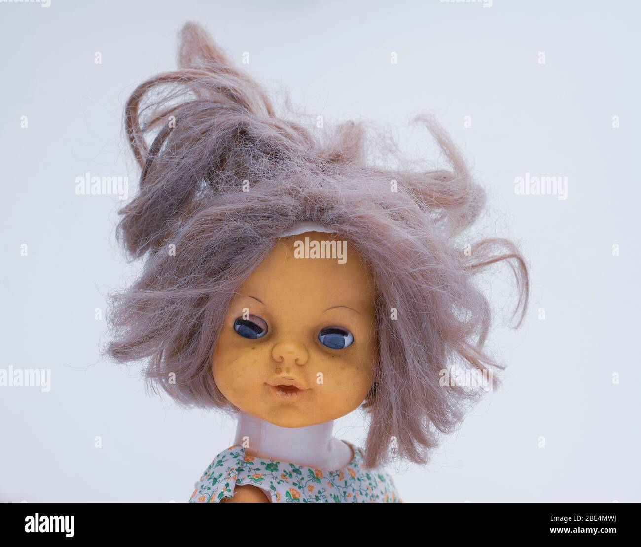 Portrait of vintage doll with bad grey hair and strange blue eyes Stock Photo