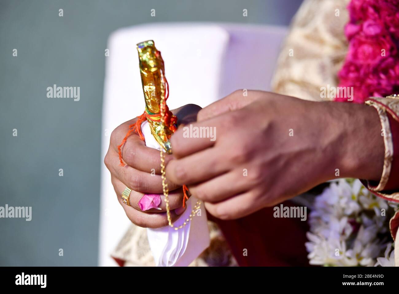 Indian groom holding a wedding knife kirpan Stock Photo