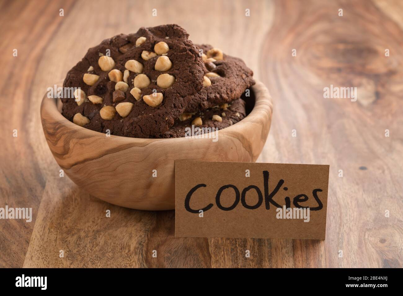 homemade heart shaped chocolate cookies with hazelnuts on wood table
