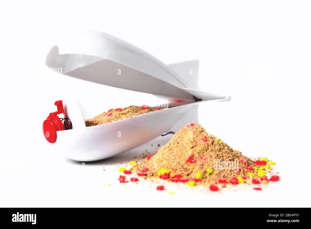 Rocket-type feeder feeder with bait inside, white on a white background, bait slide in the foreground, front view close-up isolate Stock Photo
