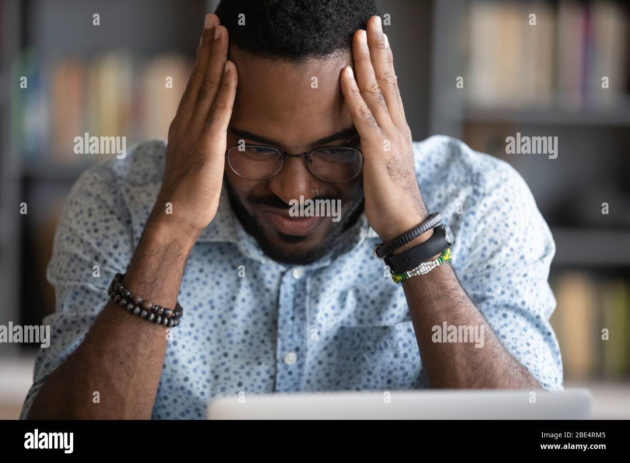 Depressed worried african ethnicity guy feeling anxious. Stock Photo