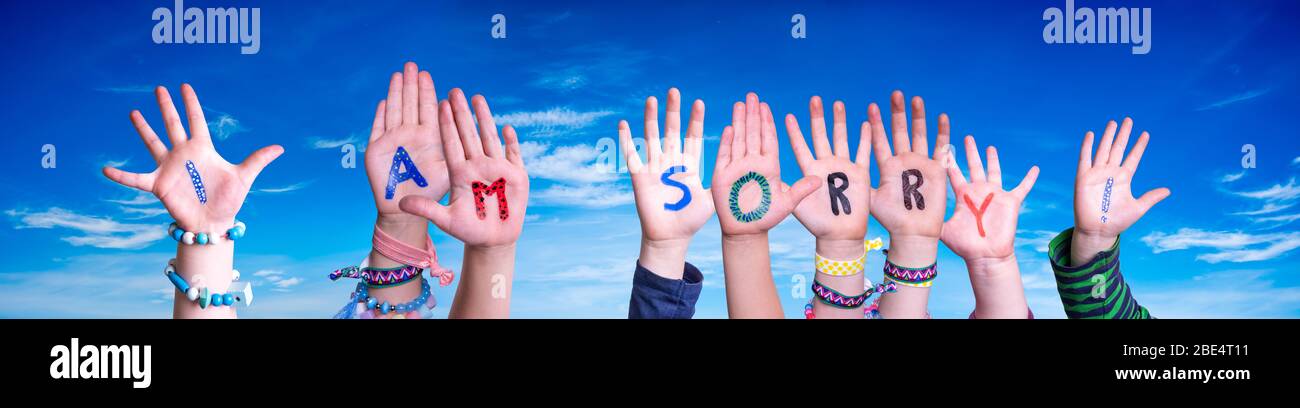 Children Hands Building Word I Am Sorry, Blue Sky Stock Photo