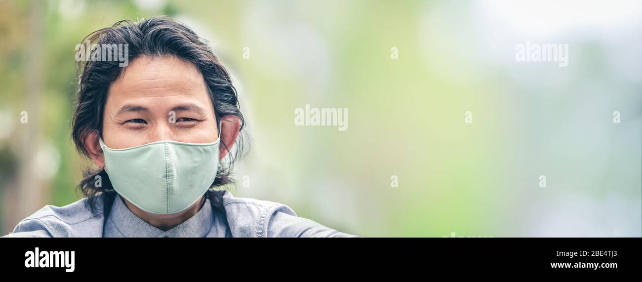Business man wearing a cloth mask in public area protect himself from risk of disease, people prevent infection from coronavirus Covid-19 or Air Stock Photo