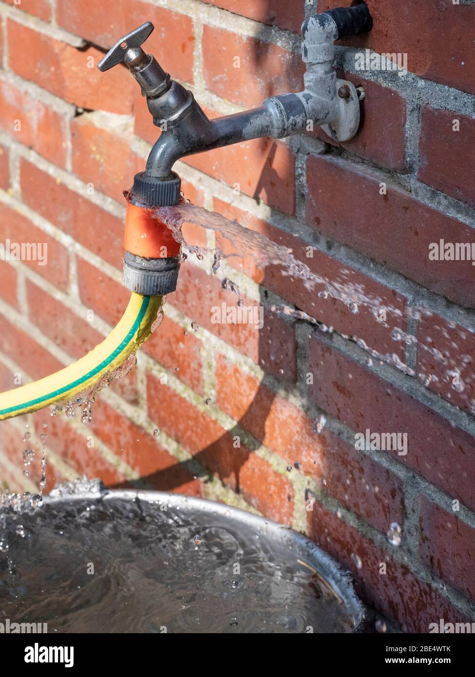 Defective faucet. leaking hose on an outside tap Stock Photo Alamy