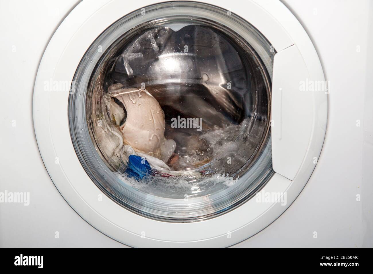 Cleaning washing machine cloth door hires stock photography and images