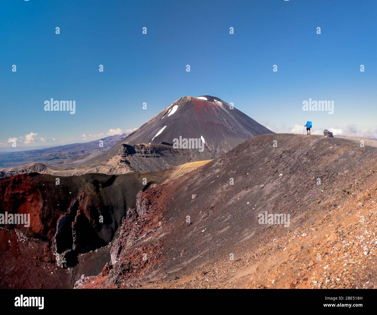 Backpacker looking at Mt Ngauruhoe (aka Mt Doom) and Red Crater in New Zealand’s Tongariro national park. Stock Photo