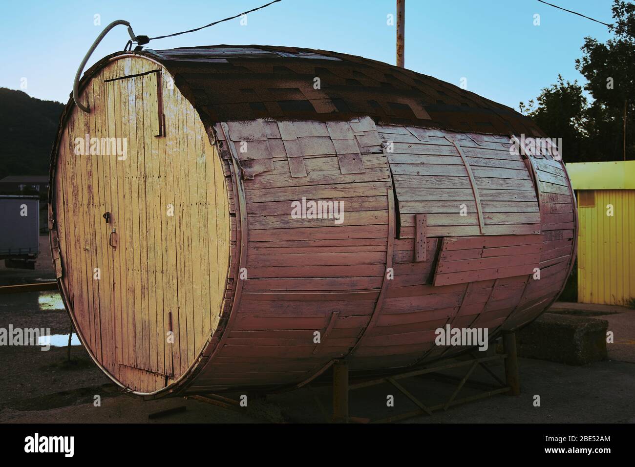 Unique dwelling in the form of a large wooden barrel Stock Photo