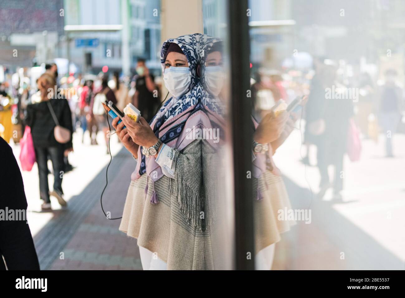 Hong Kong, China. 12th Apr, 2020. People wear surgical face mask on the street. Corona Virus (Covid19) cases in Hong Kong have reached over 1,000 on Saturday as authorities urged the public to stay at home during the long Easter weekend. Credit: Keith Tsuji/ZUMA Wire/Alamy Live News Stock Photo