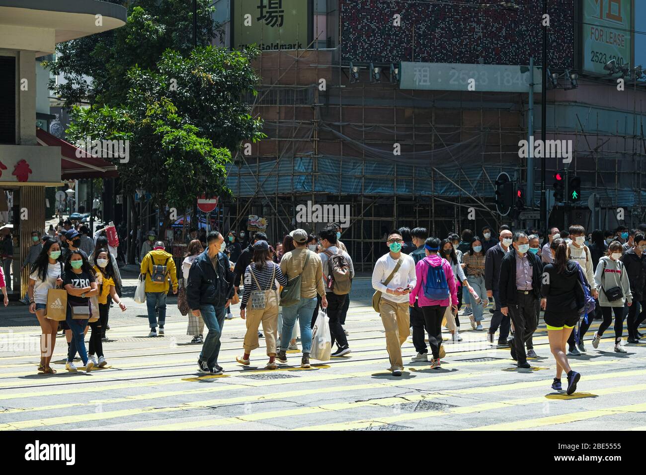 Hong Kong, China. 12th Apr, 2020. People wear surgical face mask as they cross the street. Corona Virus (Covid19) cases in Hong Kong have reached over 1,000 on Saturday as authorities urged the public to stay at home during the long Easter weekend. Credit: Keith Tsuji/ZUMA Wire/Alamy Live News Stock Photo