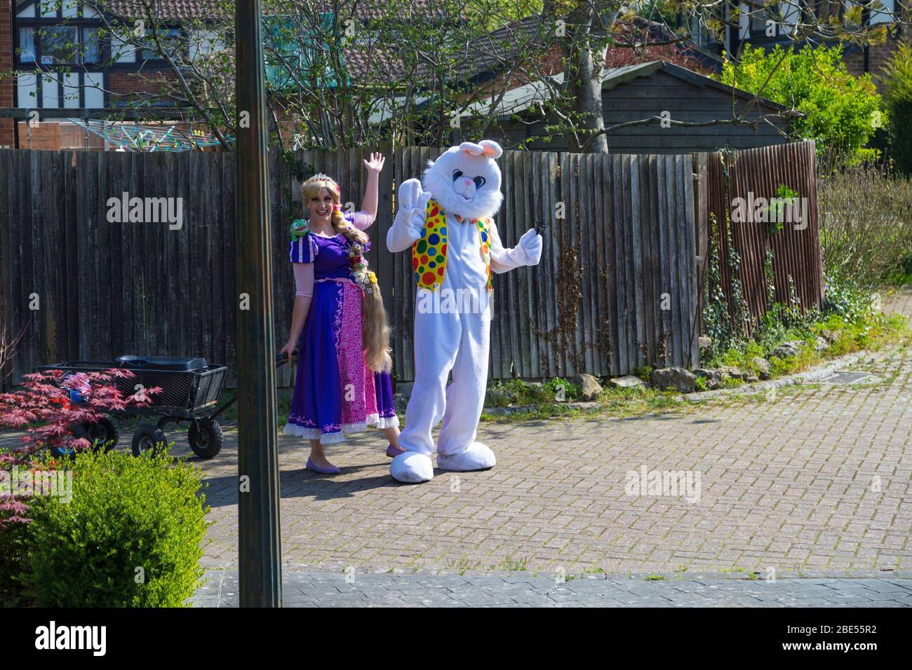 Ashford, Kent, UK. 12th Apr, 2020. Children all over the country will be missing out on an Easter egg hunt  this morning due to the coronavirus pandemic, so this couple from the village of Hamstreet near Ashford in Kent bring a bit of joy to the streets dressed as the Easter bunny and Rapunzel. ©Paul Lawrenson 2020, Photo Credit: Paul Lawrenson/Alamy Live News Stock Photo