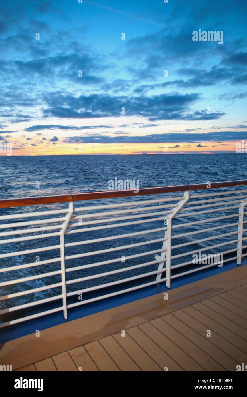 Sunset from the deck of a cruise ship across the ocean, cruising the Mediteranean Sea. Stock Photo