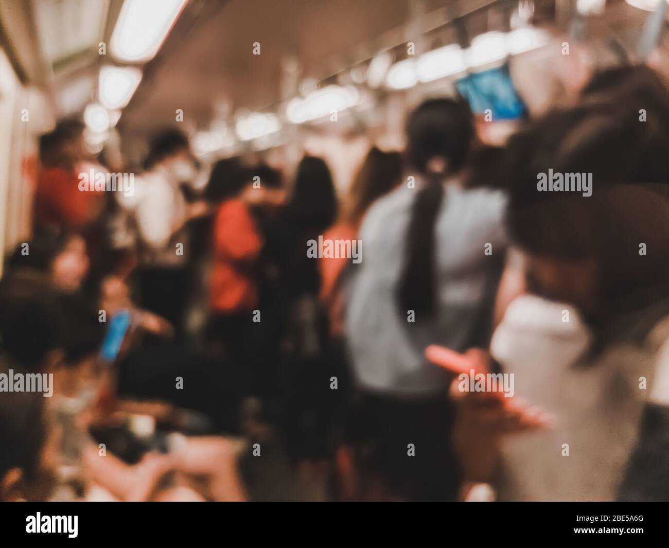 Blur scene of crowd of people cram into a metro train during the evening rush hour in Bangkok, Thailand Stock Photo